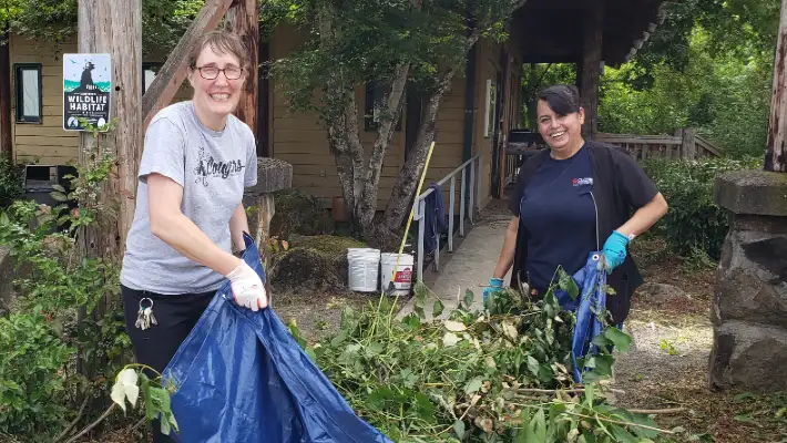 An employee and volunteer clean up around the ELC
