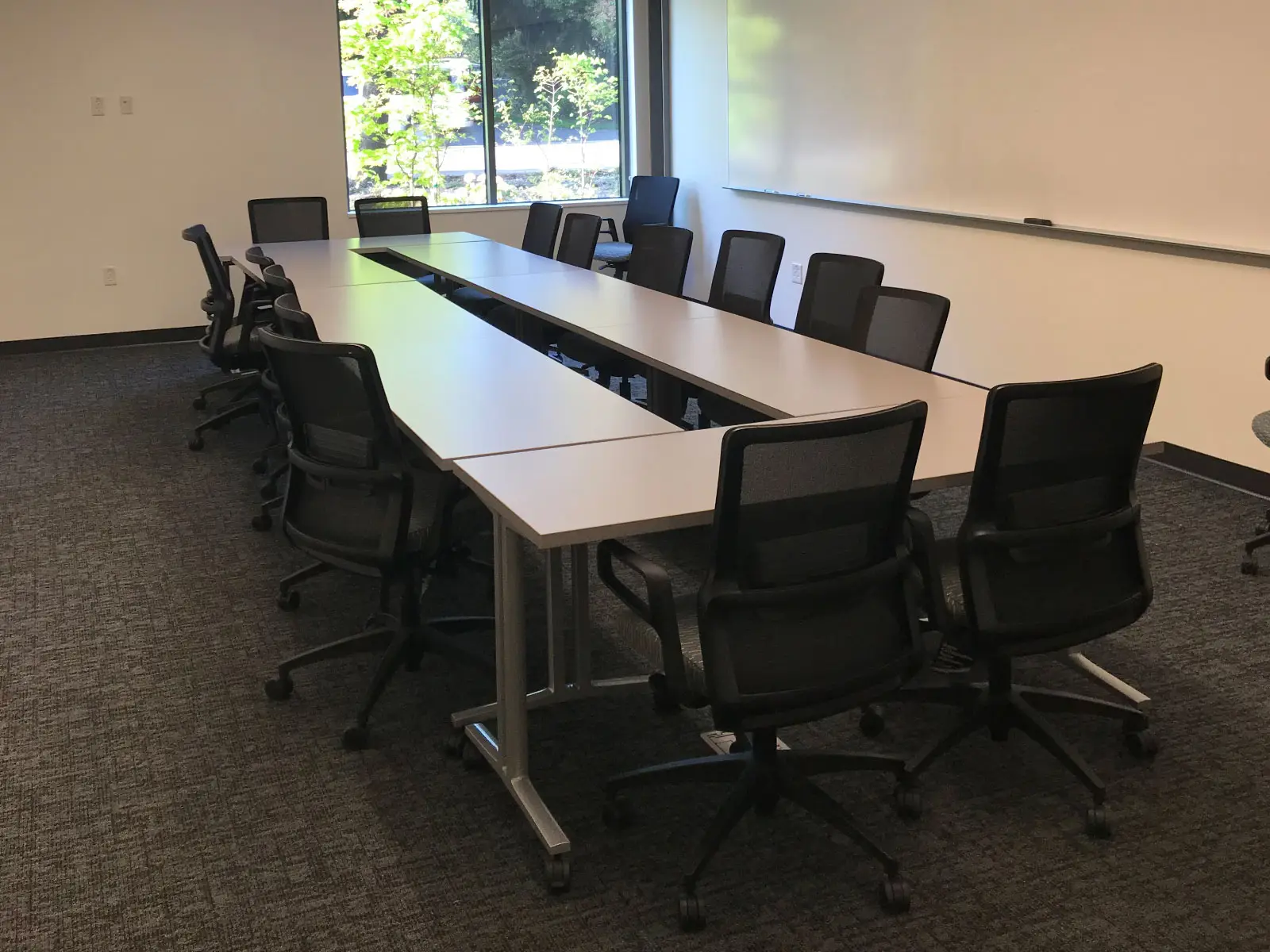 A long meeting table with many chairs in a Harmony campus conference room