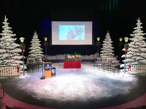 The McLoughlin theater decorated for Christmas, with snow, trees, podium and display in Niemeyer Center